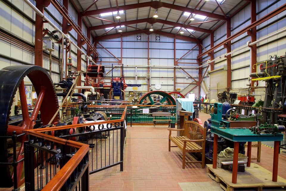 A large industrial building with heavy machinery, large gears, and metal structures.
