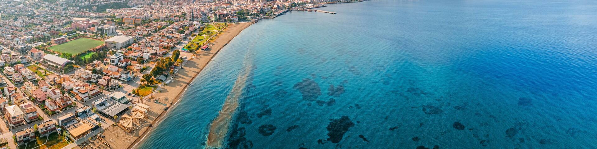Stunning aerial view of Dikili coastline, bathed in the warm glow of sunset, showcasing the beautiful turquoise waters of the Aegean Sea