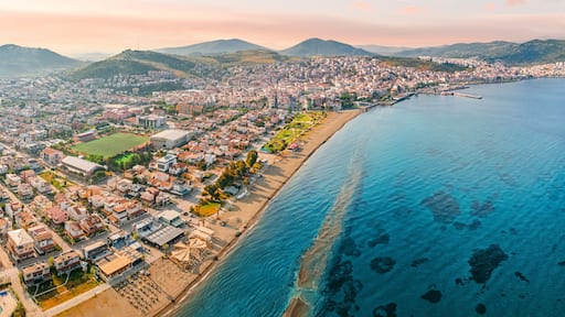 Stunning aerial view of Dikili coastline, bathed in the warm glow of sunset, showcasing the beautiful turquoise waters of the Aegean Sea