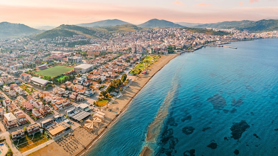 Stunning aerial view of Dikili coastline, bathed in the warm glow of sunset, showcasing the beautiful turquoise waters of the Aegean Sea