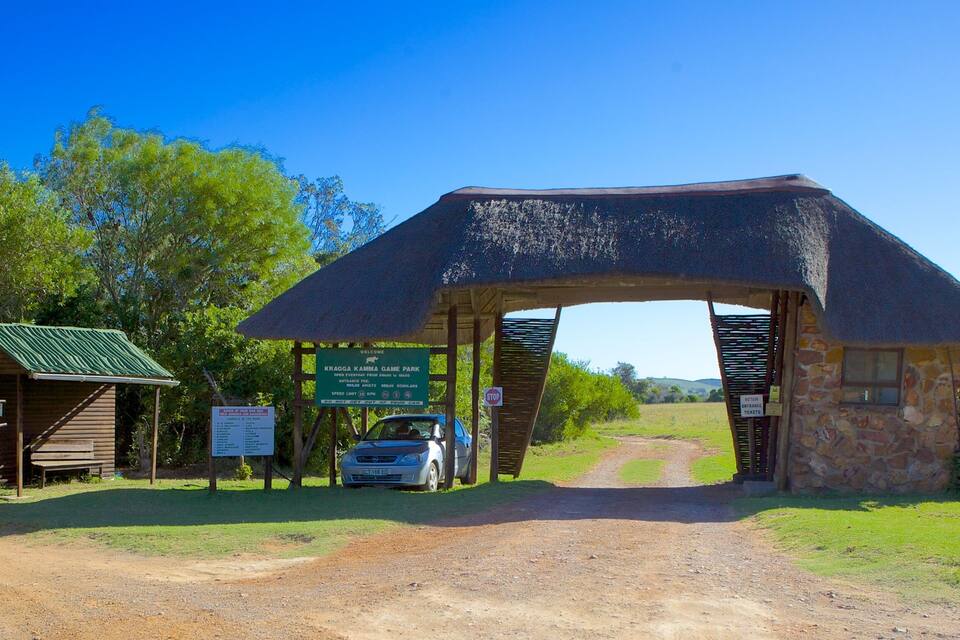 A wooden archway with a sign reading "Kragga Kama Game Park" and a car parked nearby.