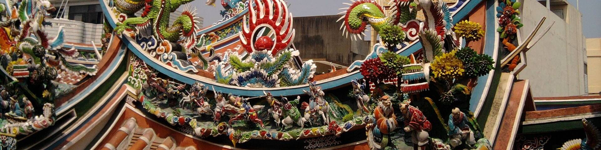 A dragon boat with intricate designs and figures on its side.