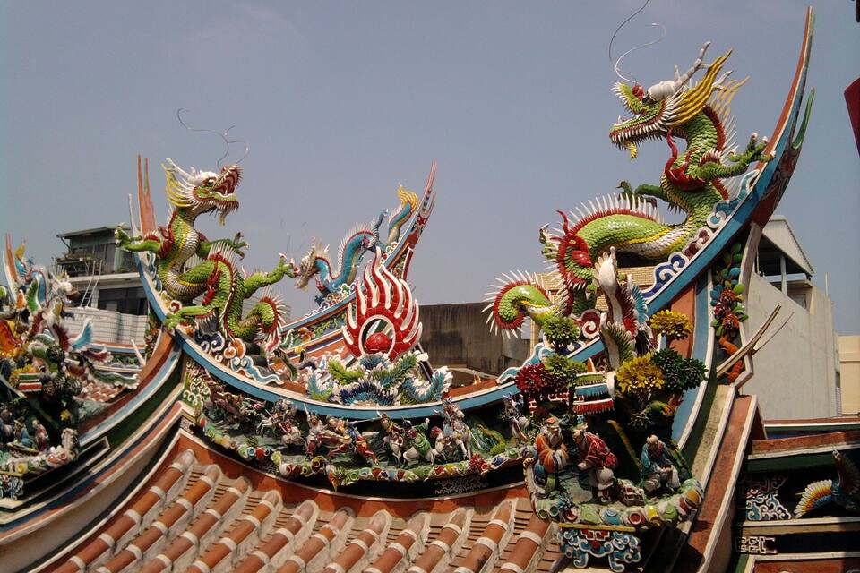 A dragon boat with intricate designs and figures on its side.