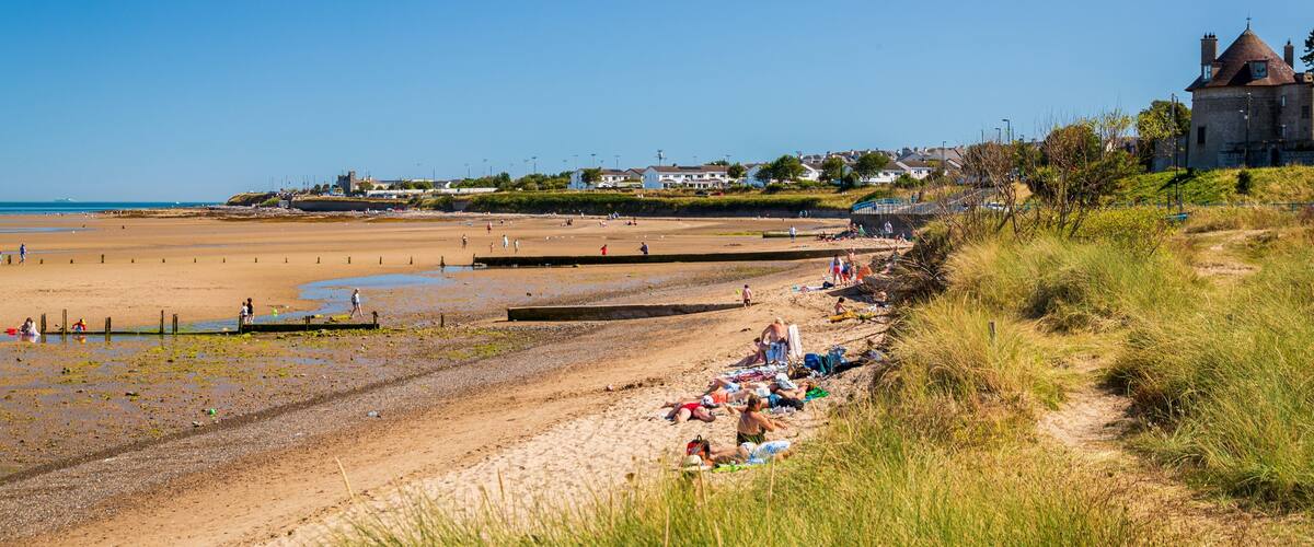Malahide Beach which includes a sandy beach and general coastal views