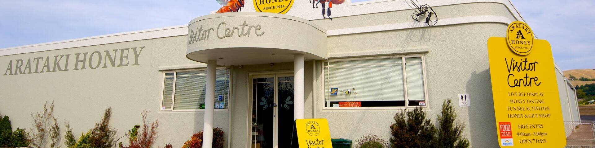 A building with a sign reading "Visitor Centre" and "Arataki Honey".
