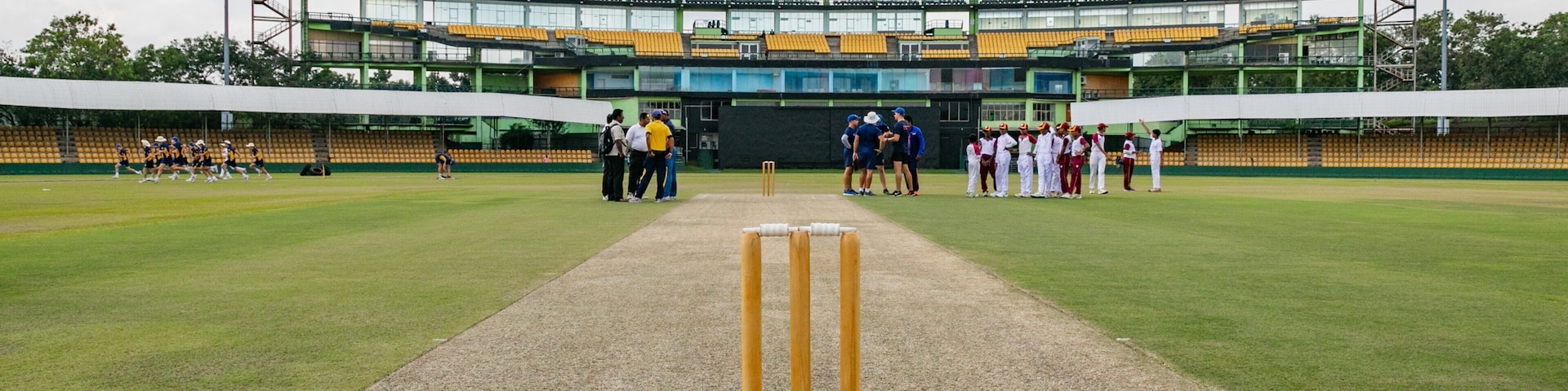 Rangiri Dambulla International Stadium showing a sporting event as well as a small group of people