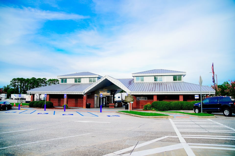 A building with a sign that reads "Rest Area No. 1" and a parking lot with marked handicapped spaces.