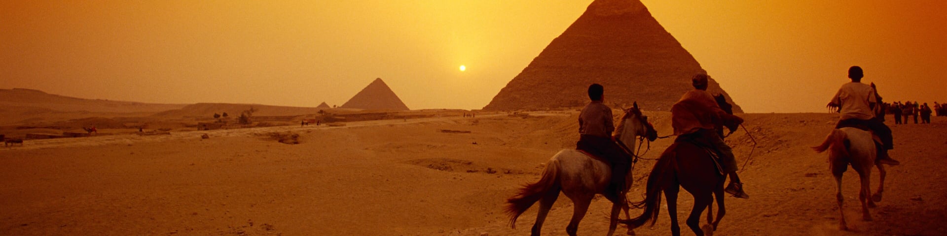 People riding horse by the Great Pyramids, Giza, Egypt