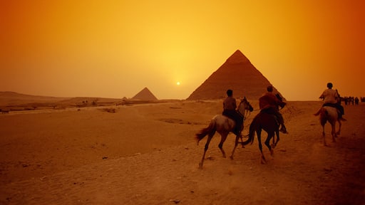 People riding horse by the Great Pyramids, Giza, Egypt