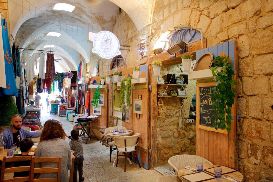 A narrow street with shops and a café.