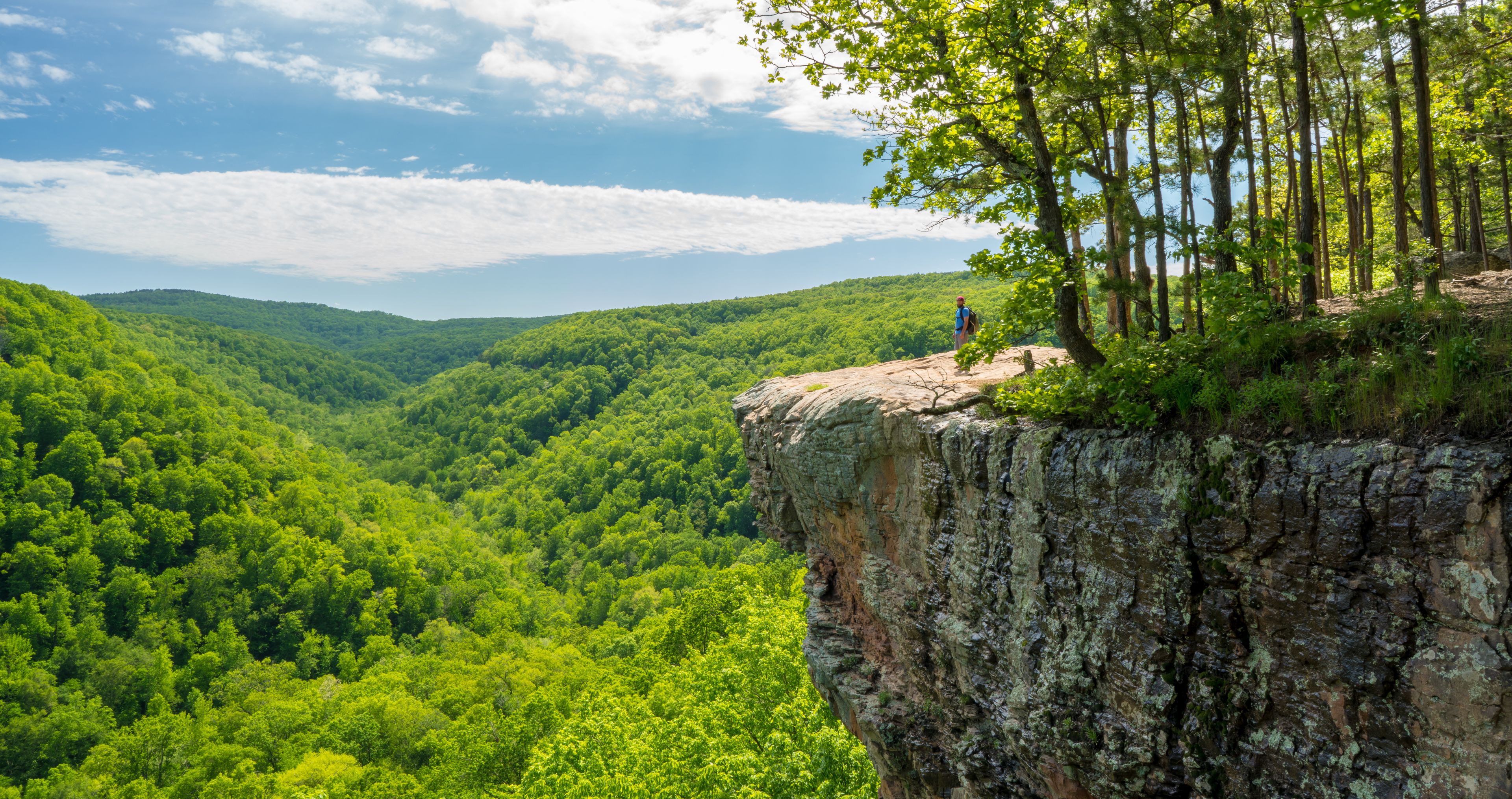 Tourist visitors couple taking pictures at Whitaker Point rock cliff hiking trail, landscape view, Ozark mountains, nwa northwest arkansas