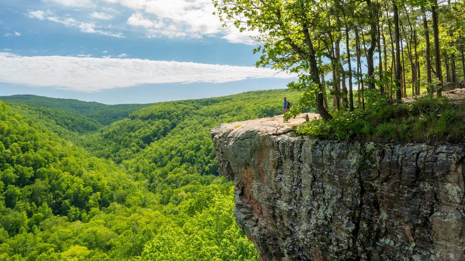 Tourist visitors couple taking pictures at Whitaker Point rock cliff hiking trail, landscape view, Ozark mountains, nwa northwest arkansas