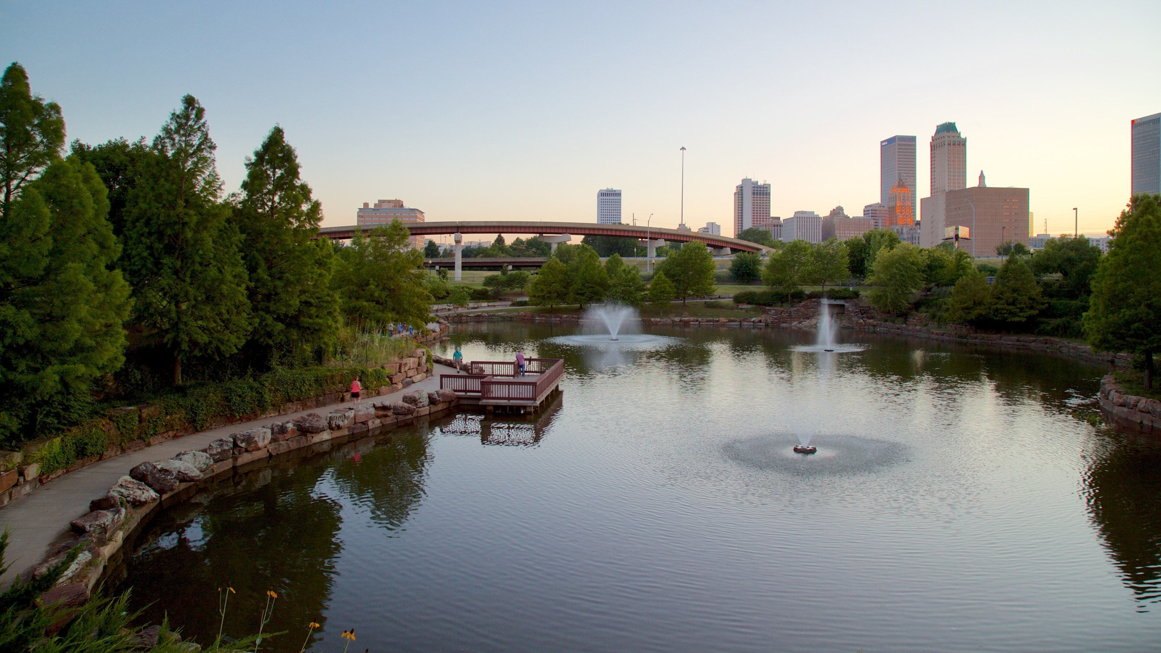 Centennial Park which includes a high-rise building, a pond and a fountain