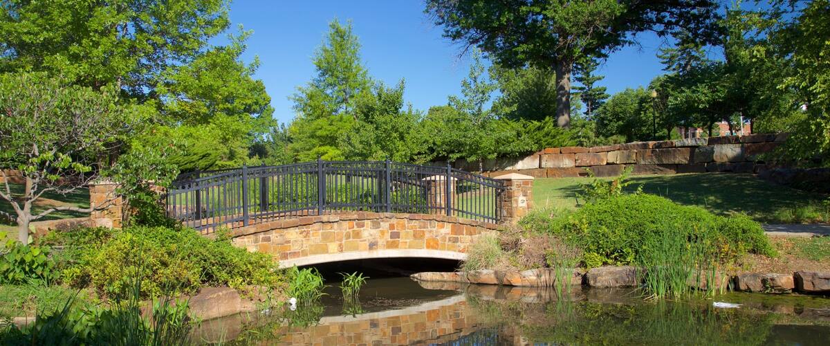 Centennial Park which includes a river or creek, a park and a bridge