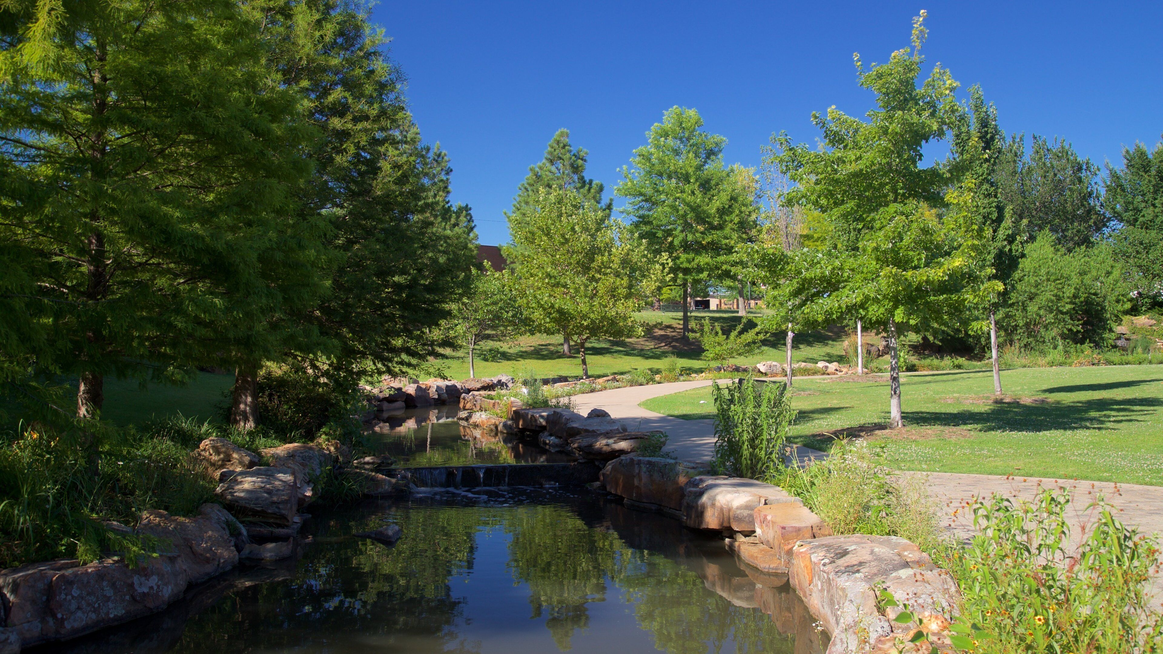 Centennial Park featuring a river or creek and a garden