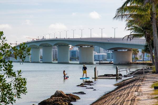 Causeway Park which includes a bridge and a river or creek as well as a couple