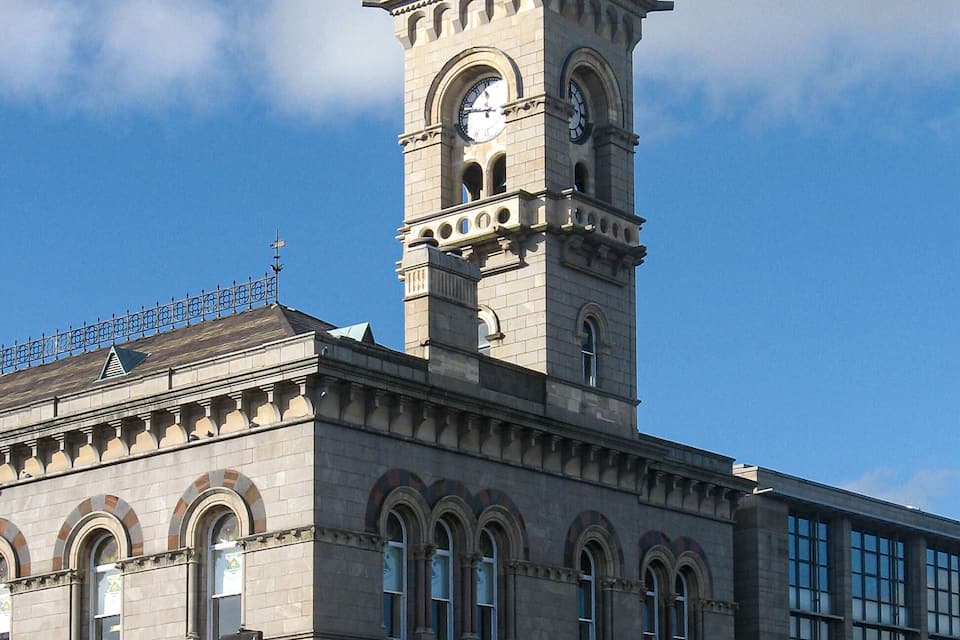 A historic building with a clock tower and arched windows.