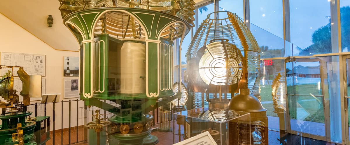 Ponce de Leon Inlet Lighthouse and Museum featuring a lighthouse and interior views