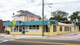 A yellow storefront with 'Antiques & Things' signage, a pedestrian crossing sign, and a 'San Marco' address sign.