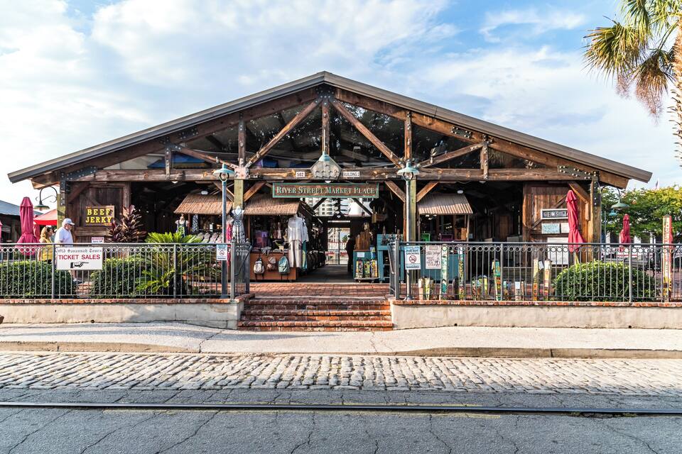 A rustic building with a sign reading "River Street Market Place" and "Beer Jerky".