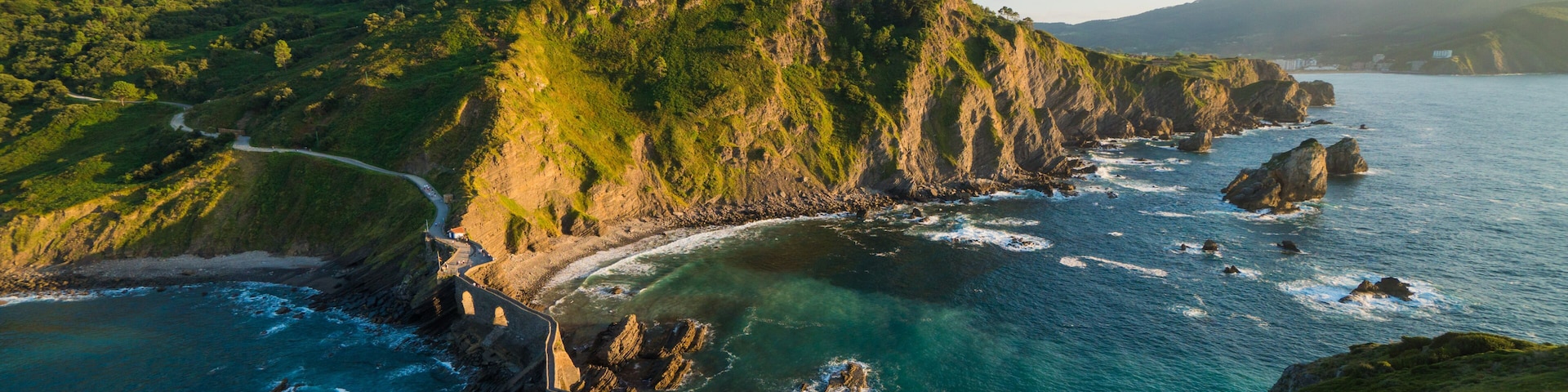 Beautiful scenic view at sunset of the north coast of Spain, by the island of San Juan de Gaztelugatxe, a fortress in Basque Country