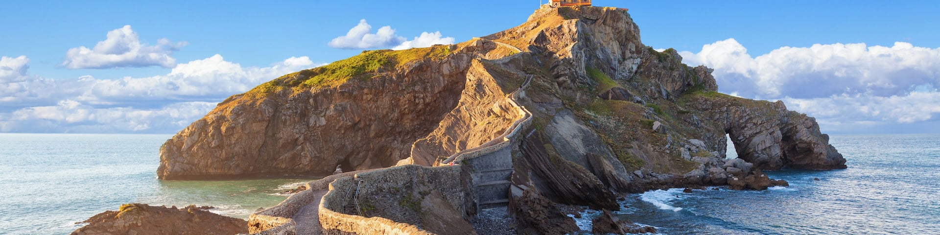 Gaztelugatxe is an islet with a popular church on top. It is connected to the mainland by a man-made bridge. Coast of Biscay near Bermeo, in Basque Country, Spain.