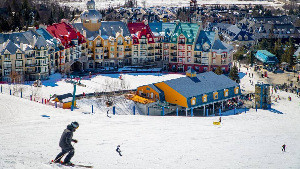 A ski resort with colorful buildings and a snow-covered slope.