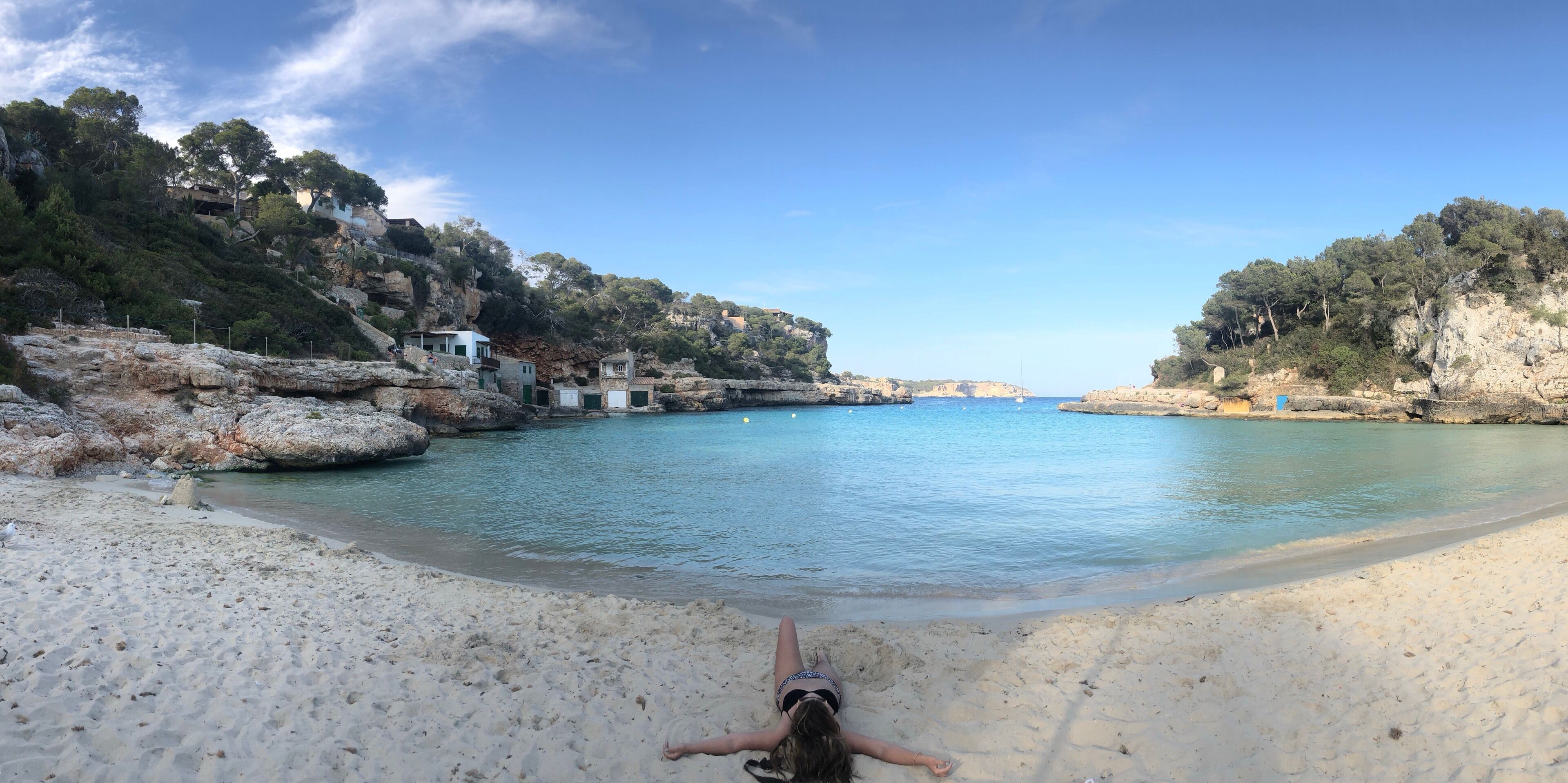 Gorgeous beach with a cute little beach bar and chairs and umbrellas for rent in southern Mallorca, Spain.