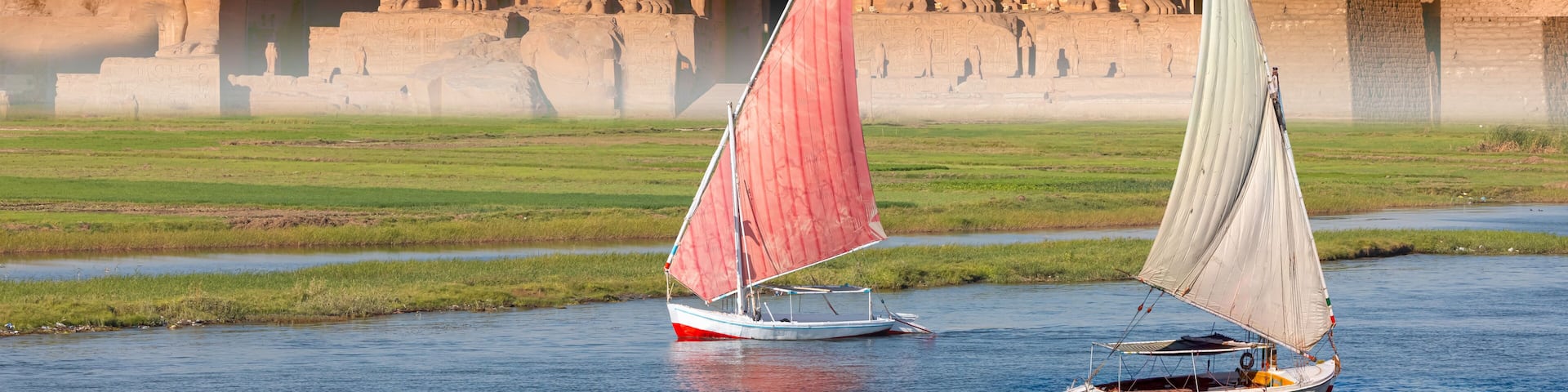 Beautiful Nile scenery with sailboat in the Nile on the way to The Front of the Abu Simbel Temple - Egypt, Africa