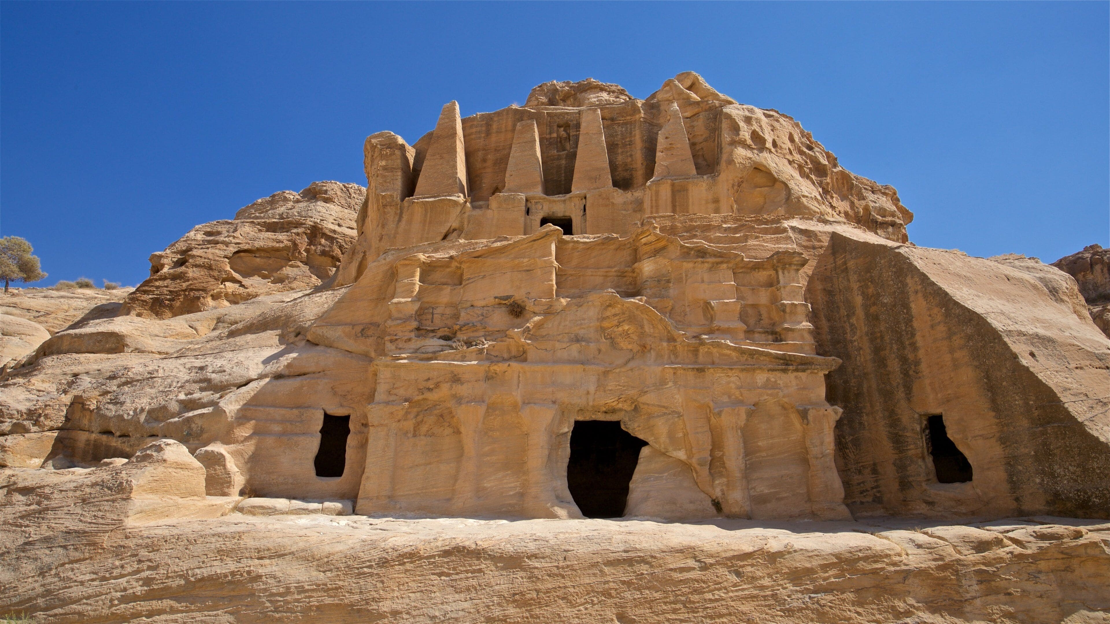 Obelisk Tomb which includes building ruins, heritage architecture and a gorge or canyon