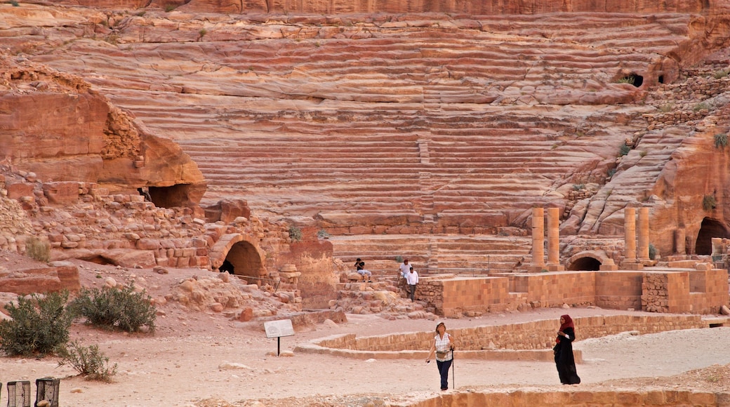 Nabatean Theater featuring building ruins and heritage elements as well as a small group of people