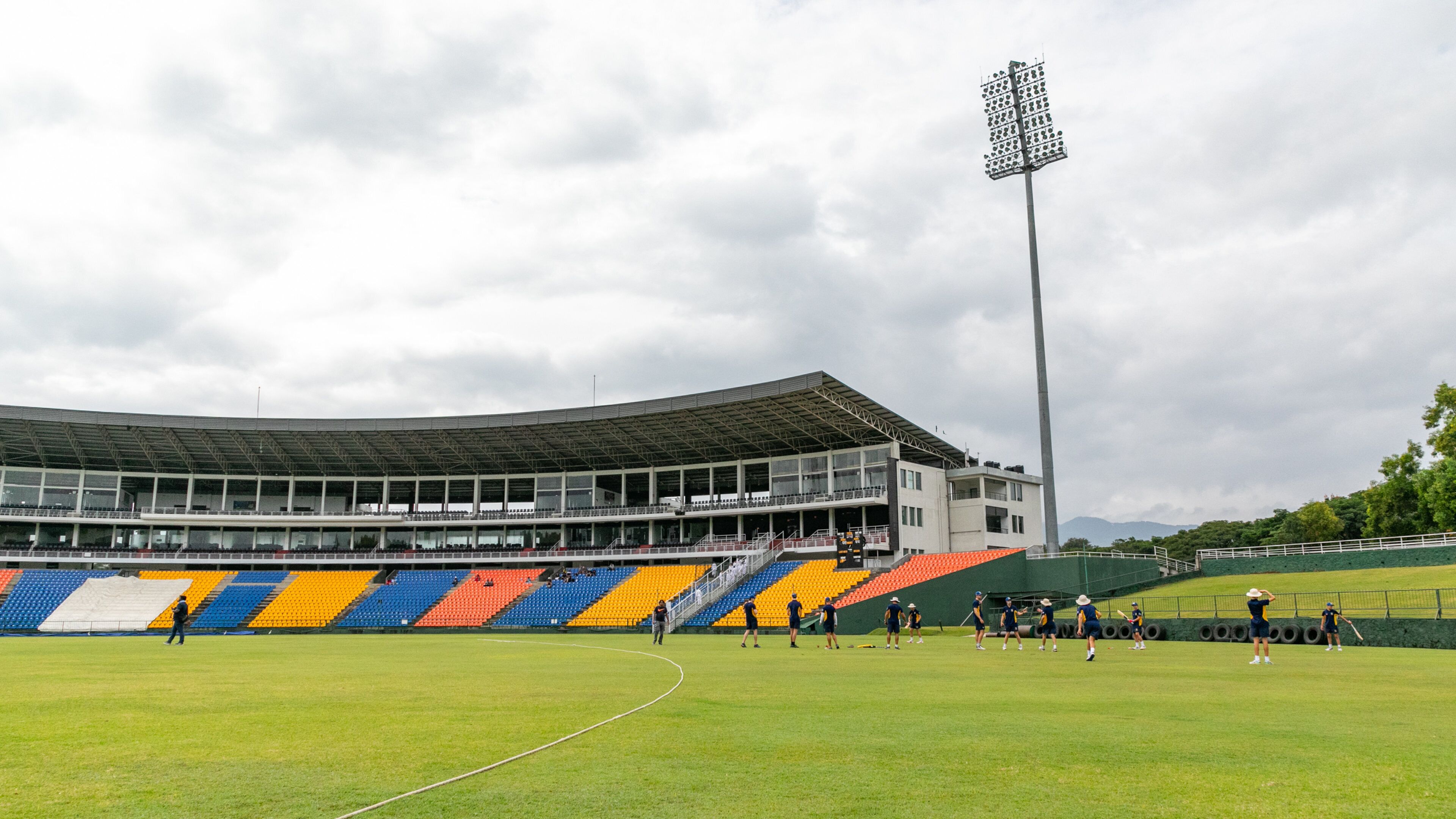 Pallekele International Cricket Stadium featuring a sporting event as well as a small group of people