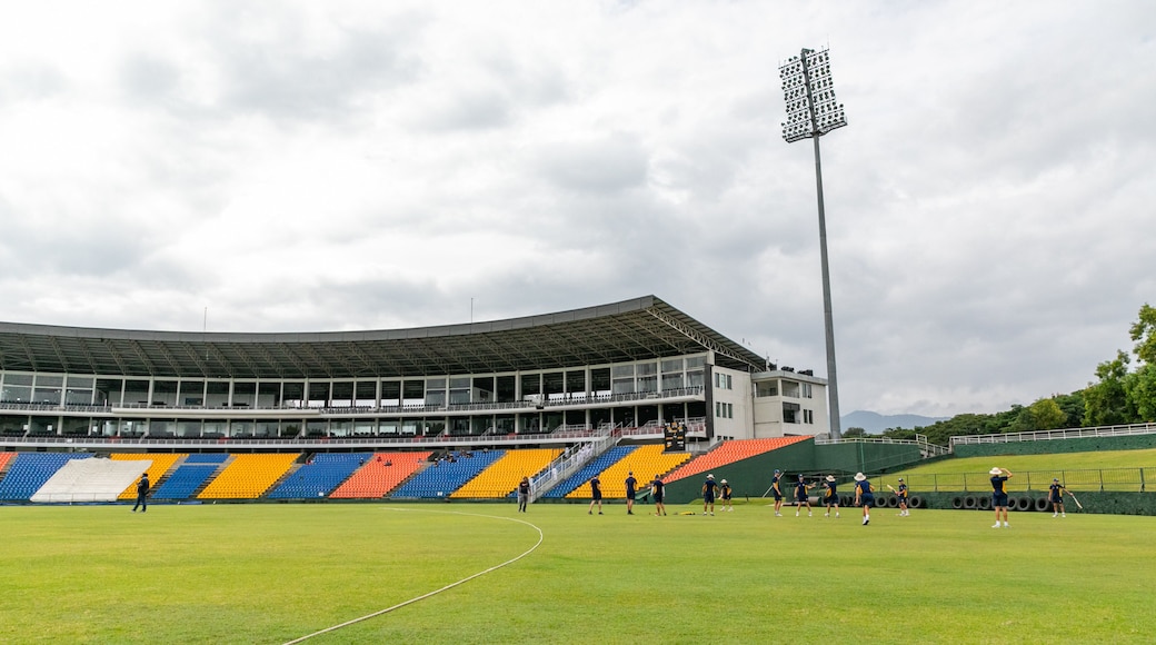 Pallekele International Cricket Stadium featuring a sporting event as well as a small group of people