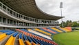 A stadium with tiered seating in blue, orange, and yellow.