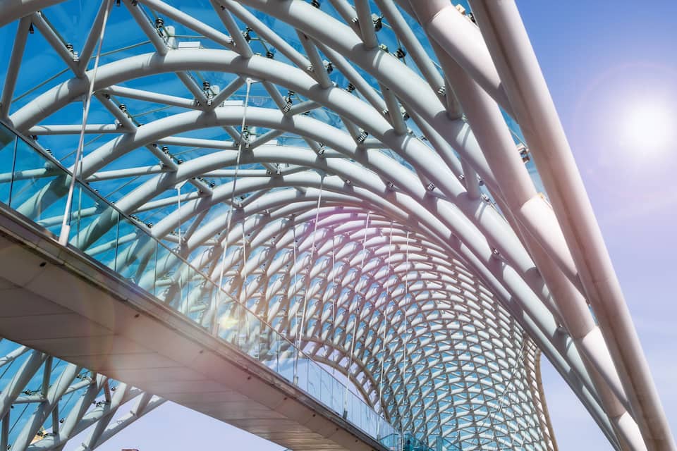A modern architectural structure with a glass and metal framework.
