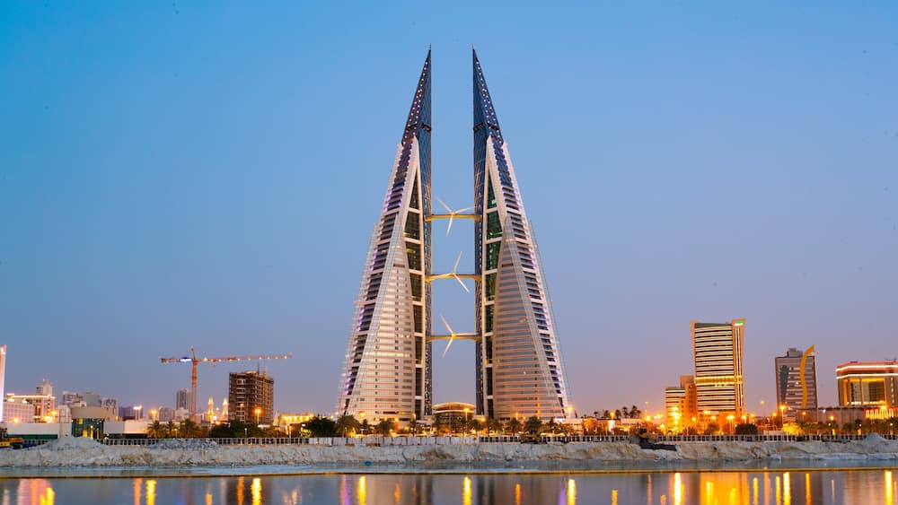 Bahrain World Trade Center which includes a city, modern architecture and night scenes