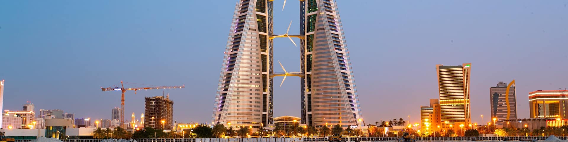 Bahrain World Trade Center which includes a city, modern architecture and night scenes