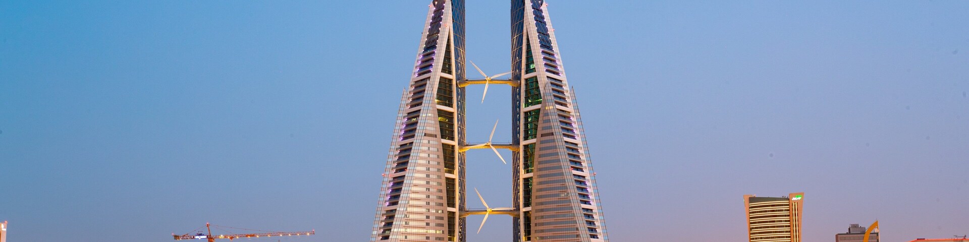 Bahrain World Trade Center which includes a city, modern architecture and night scenes
