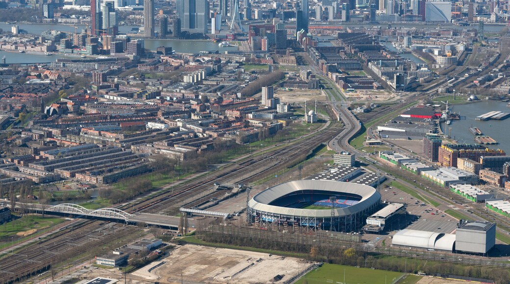Rotterdam, The Netherlands - March 2020: Aerial photo of Feyenoord stadium De Kuip, with all of downtown Rotterdam in the background.