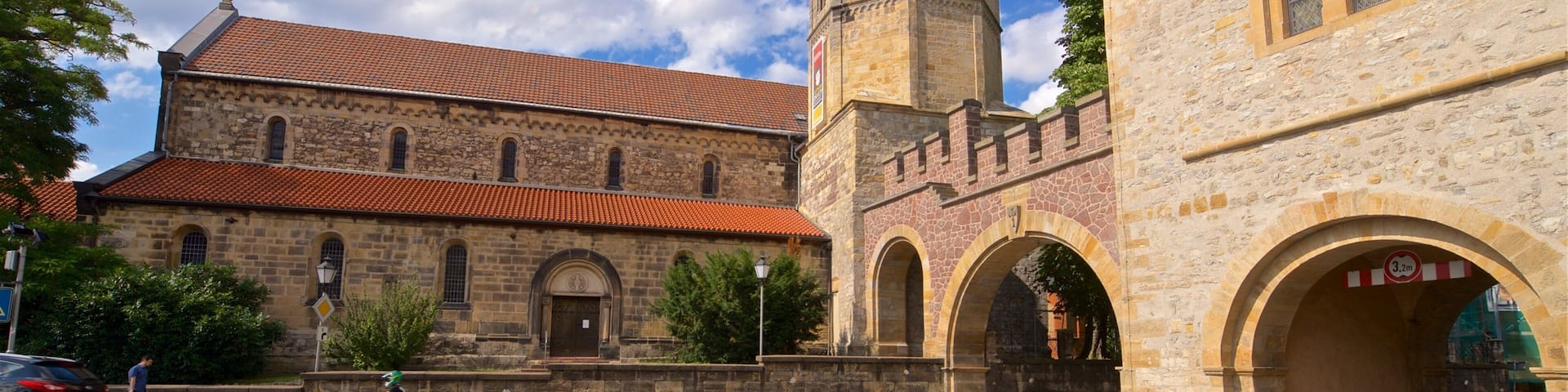 A historic building with a tall tower and arched windows.