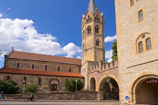 A historic building with a tall tower and arched windows.