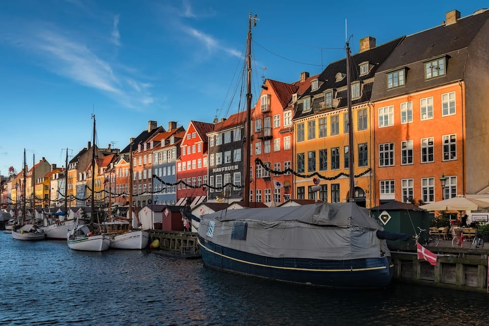 A canal lined with colorful buildings and boats docked along the water.