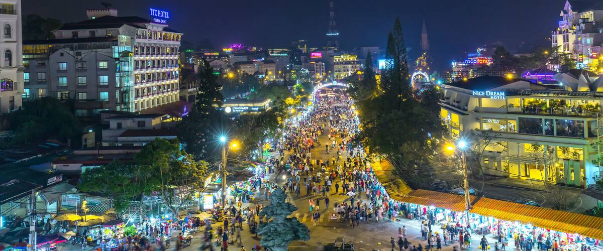 Da Lat, Vietnam - May 12th, 2017: Da Lat Market night skyline night view with lights attracts thousands of people walking along the road shopping crowded bustle of city tourism in Da Lat, Vietnam