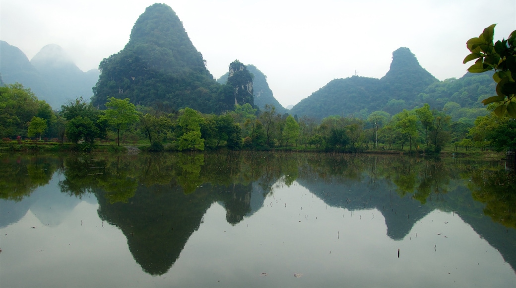 Yangshuo Park featuring a gorge or canyon, a lake or waterhole and mist or fog