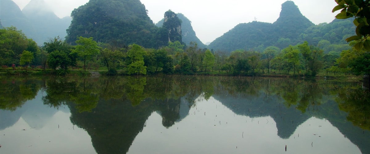 Yangshuo Park featuring a gorge or canyon, a lake or waterhole and mist or fog