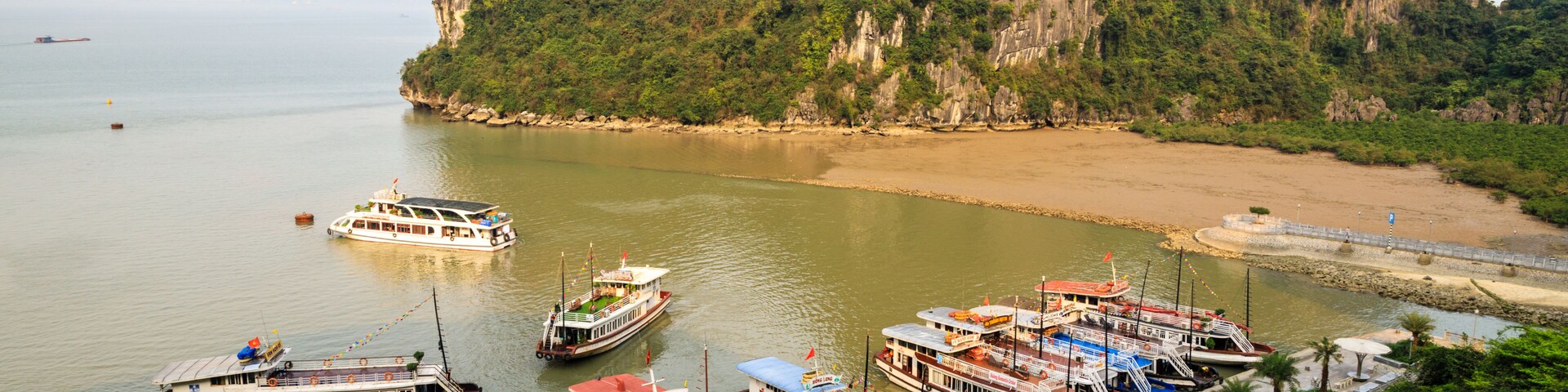 Tourist boats at Dau Go Island to visit a cave, Halong Bay, Vietnam, 2019