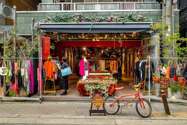 America Village featuring shopping as well as an individual femail