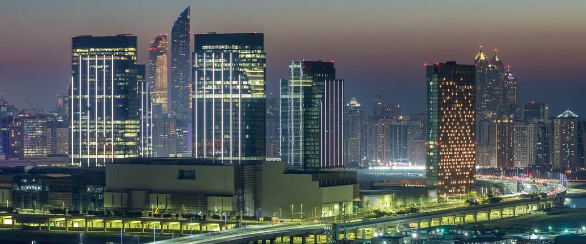 Buildings on Al Reem island in Abu Dhabi day to night timelapse from above.