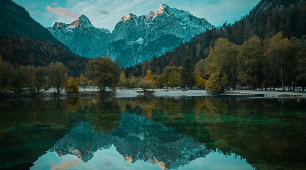 Beautiful lake jasna in kranjska gora with visible reflections of Razor and Skrlatica in the water in early autumn