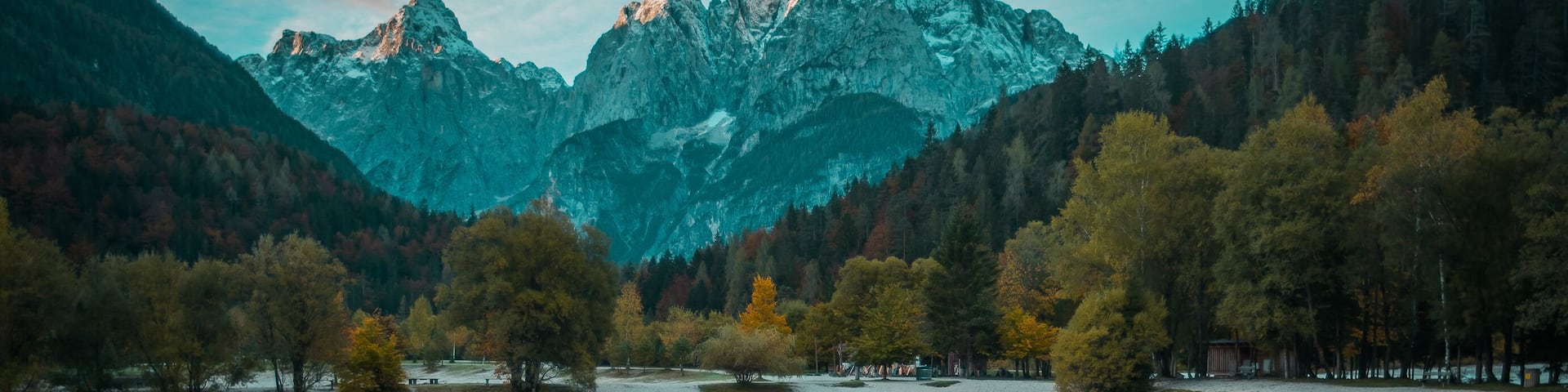 Beautiful lake jasna in kranjska gora with visible reflections of Razor and Skrlatica in the water in early autumn